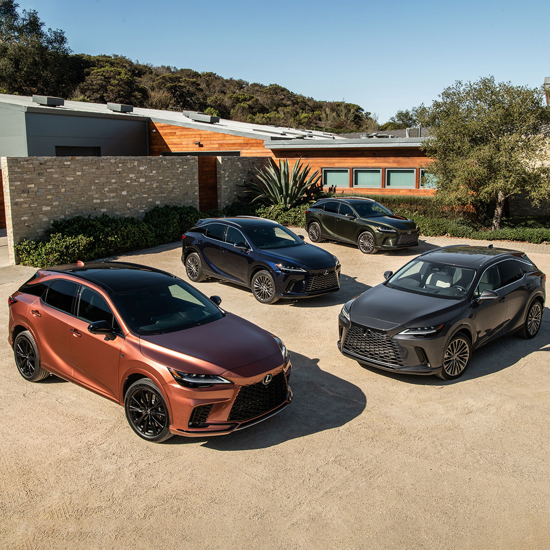 4 differently coloured and equipped RX models are parked in front of a luxury home.