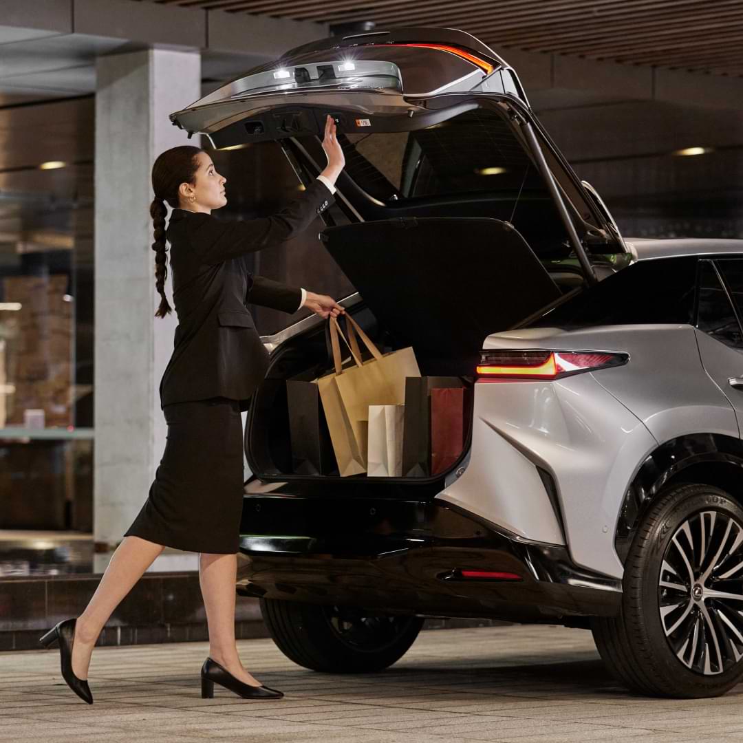 Person loading the booth of a car.