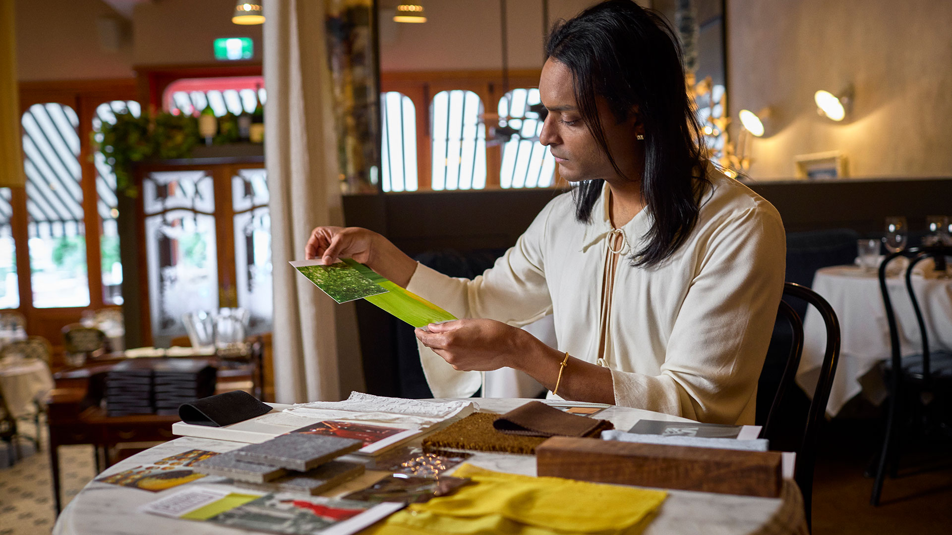 Interior designer Brahman Perera looks samples of cloth
