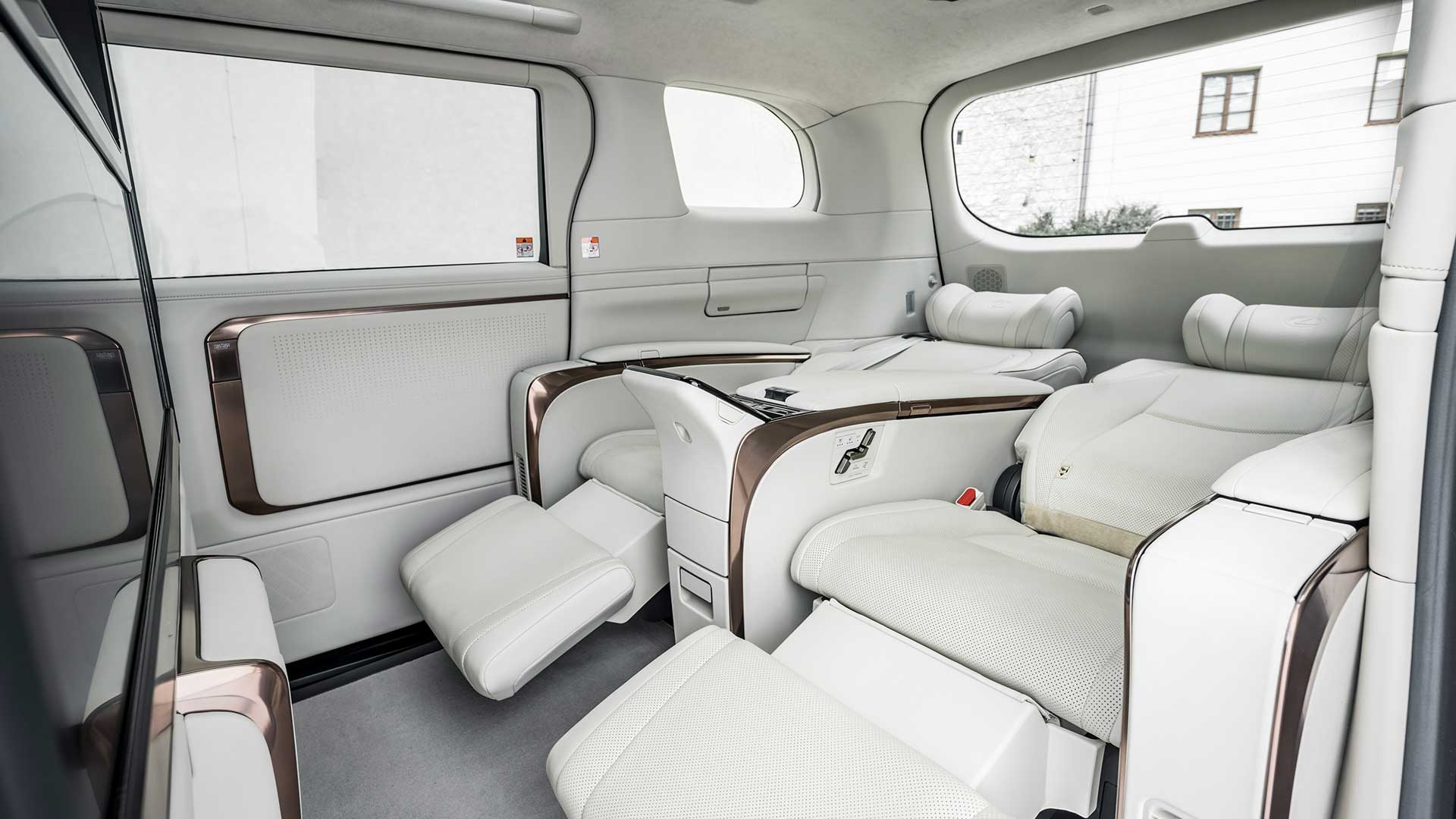 The back seat cabin of the Lexus LM 500h Ultra Luxury in white.