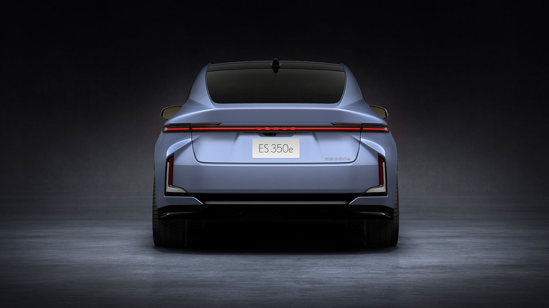 Light blue 2026 Lexus ES 350e all-electric sedan, rear view  in studio setting.