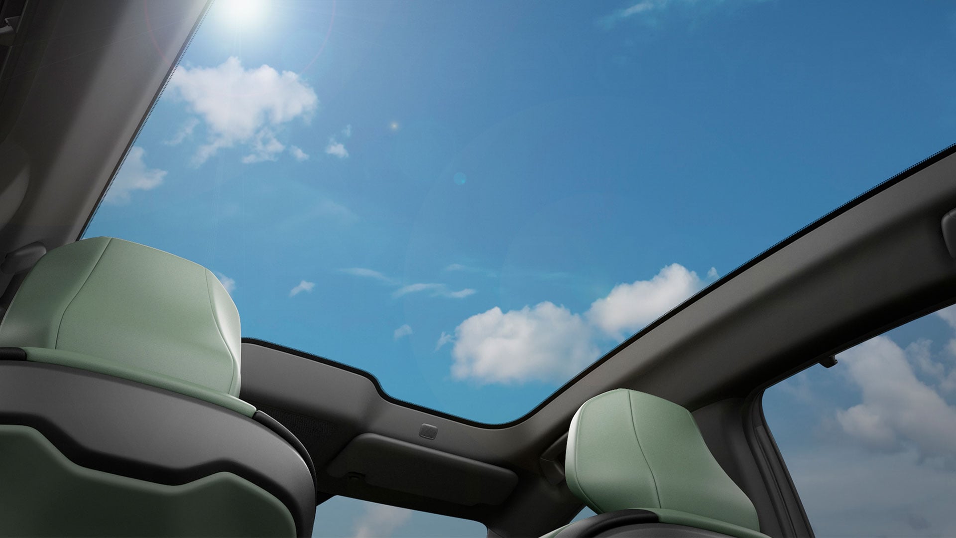 Interior view of a Lexus ES large panoramic sunroof looking up at blue sky with white clouds. 