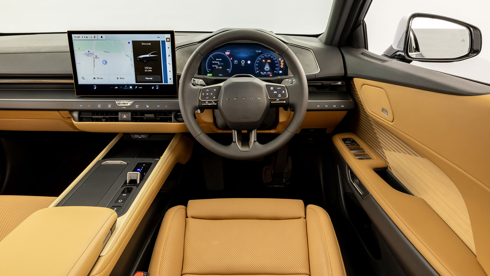 Interior of the Lexus ES showing the dashboard, steering wheel, digital displays and tan leather trim