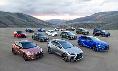 Lexus range multiple models and colours on a gravel road with mountains in the background.