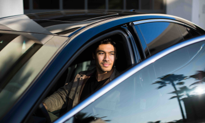 Man sitting in a Lexus, the sun is shining on his face.