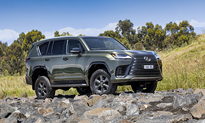 2025 Lexus LX Overtrail SUV in Nori Green Pearl off-road on a rocky path